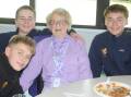 Dorothy Annetts is enjoying new friendships with Scots College students including Sam Dunn, Xander Taylor and Clive Reithmuller. Picture by Glenn Ellard.