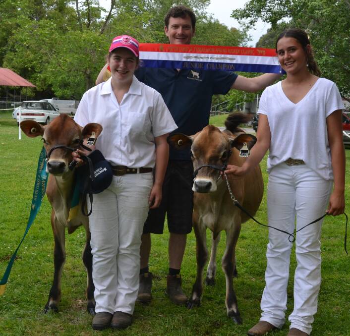 DOUBLE: Elly Simms (right) claimed junior champion with Rivendell Sentry Cleo at the South Coast and Tablelands Holstein Association Spring Heifer Classic, while Iszi Crawford with Brunchilli Baurnabas Jasmina was reserve junior champion. They are being congratulated by Jared Cochrane, of Raine and Horne Nowra.