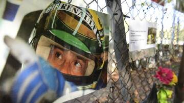 Tributes to Ayrton Senna hang on the the corner where he died at Imola in 1994. (AP PHOTO)