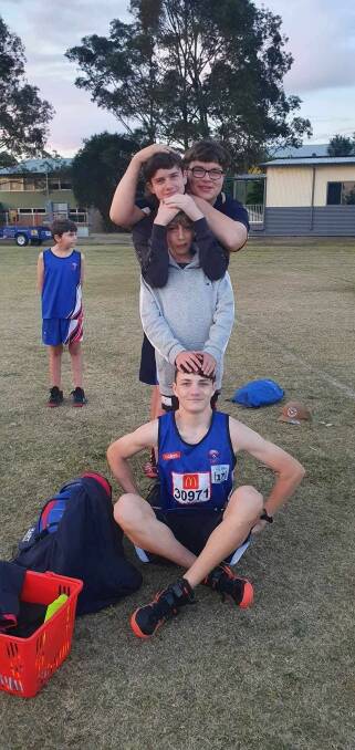 Hamish McLaren (bottom) and his friends celebrating after he again broke the javelin record. Picture supplied. 
