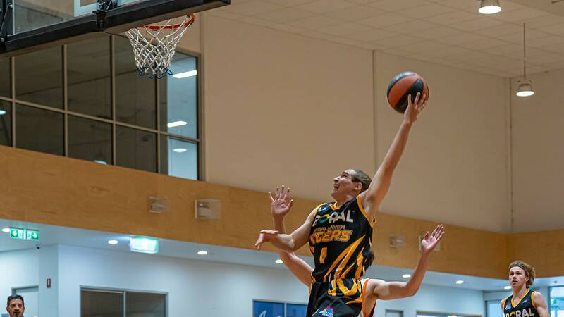Shoalhaven Tigers' Corey Walker skies to the rim against the Orange Eagles. Picture by Shoalhaven Basketball Association. 