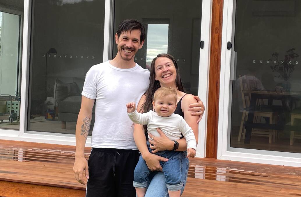 Danny Pilker, partner Loise and their one year old son Julian outside their environmentally-friendly prefabricated home. Picture by Marion Williams
