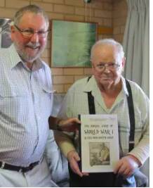Colin Tarlinton (right) takes delivery of The Unreal Story of World War 1 and the NSW South Coast from author Peter Lacey. File piicture