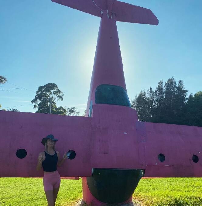 Sonia Srsan with the pink plane on the side of the Princes Highway south of Moruya. They aim to walk 100 kilometres a week to raise awareness and raise $20,000 to find a cure for brain cancer. Picture supplied