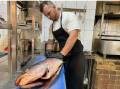 Sam Smith prepares a fish for diners at Nowra's Ponte Bar and Dining. Picture by Glenn Ellard.
