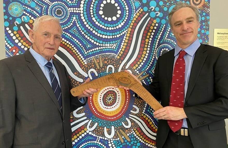 Bob Hanley OAM and Dr Mark Hanley with the boomerang carved in 1935 by George Hanley. Picture supplied.
