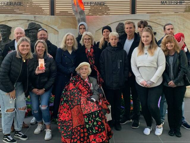 Joy Norris is surrounded by family members after being presented with the Quilt of Valour during an Anzac Day dawn service in Smithfield during 2021. Picture supplied.