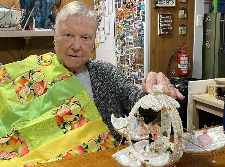 Gillian Avery of Nowra with one of the quilts she makes for people in need, funded by selling her crafts including this decorated ostrich egg. Picture by Glenn Ellard.