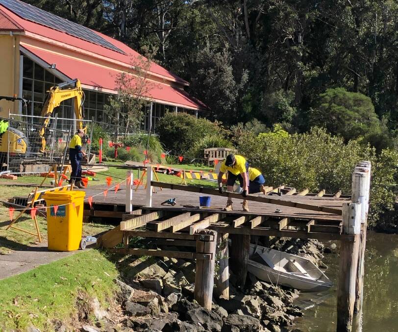 Workers dismantle the dilapidated old wharf at the Jervis Bay Maritime Museum. Picture supplied.