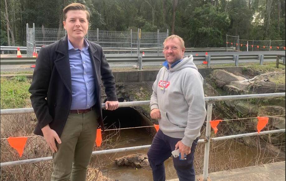 Shoalhaven Councillor Paul Ell and local resident Travis Harpley look at the sink hole at Old Erowal Bay. Picture supplied.