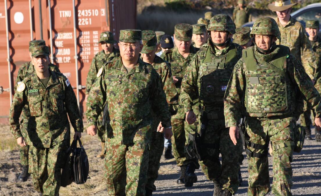 Head of the Japanese defence forces, General Yoshihide Yoshida, leads a contingent of military personnel to inspect the site for testing in country's surface to sea missiles at the Beecroft Weapons Range. Picture by Glenn Ellard.