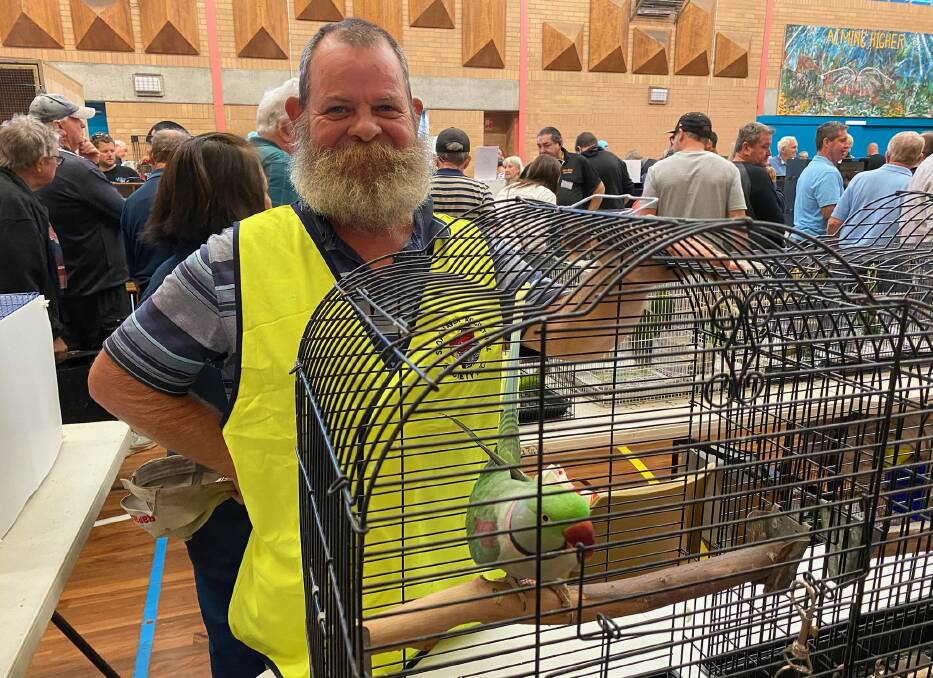 Joe Langford of Buxton was selling his Alexandrine parrot named Alex at the Shoalhaven Avicultural Society event. Picture by Glenn Ellard.