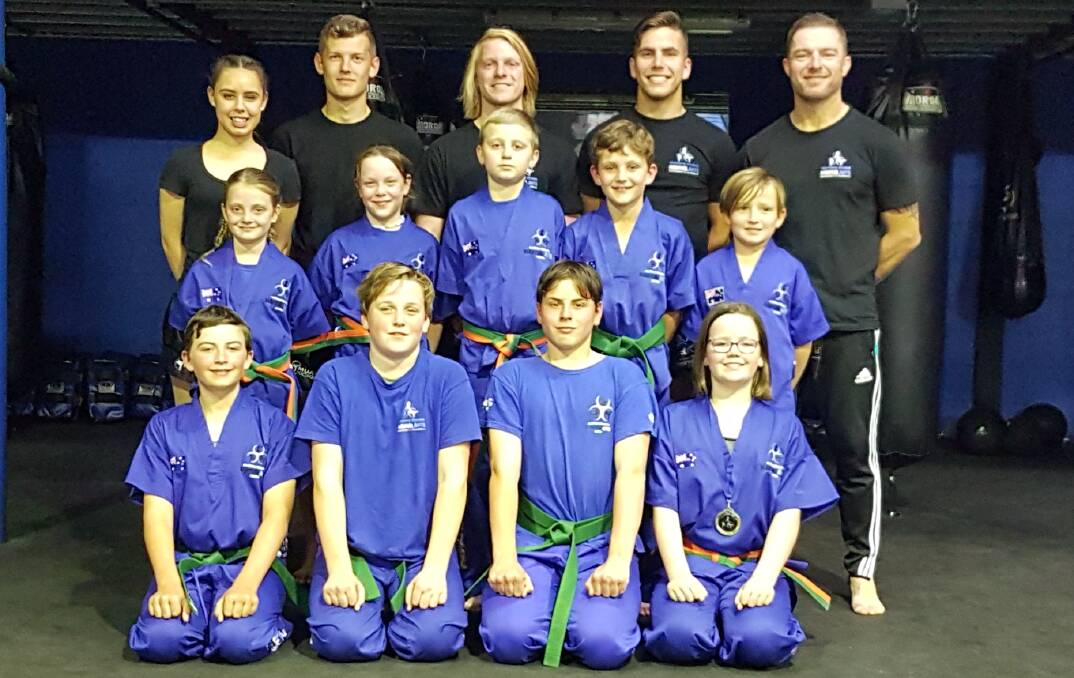 WELL DRILLED: Southern Fitness, Martial Arts and CrossFit Centre Bomaderry's orange and green belts - junior kick defence after their successful gradings.