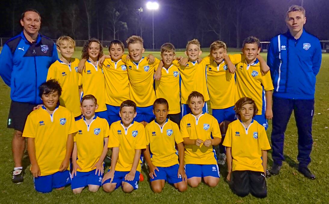 Luke Nolan (right) with fellow coach Paul Amos and a number of the the under 11 and under 12 Southern Branch players.