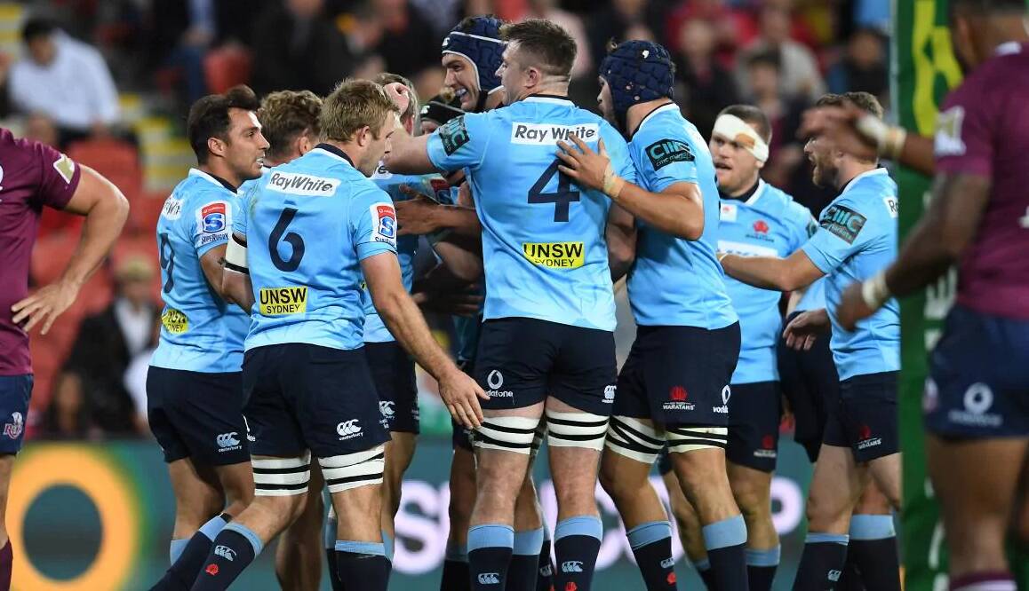 Will Miller (six) and his NSW Waratahs team mates celebrate a try against Queensland. Photo: WARATAHS MEDIA