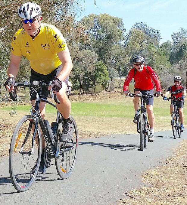 John Wooster followed by Bob Lavender and Peter Hewlett exploring Canberra cycle paths during the recent Canberra weekend away.  