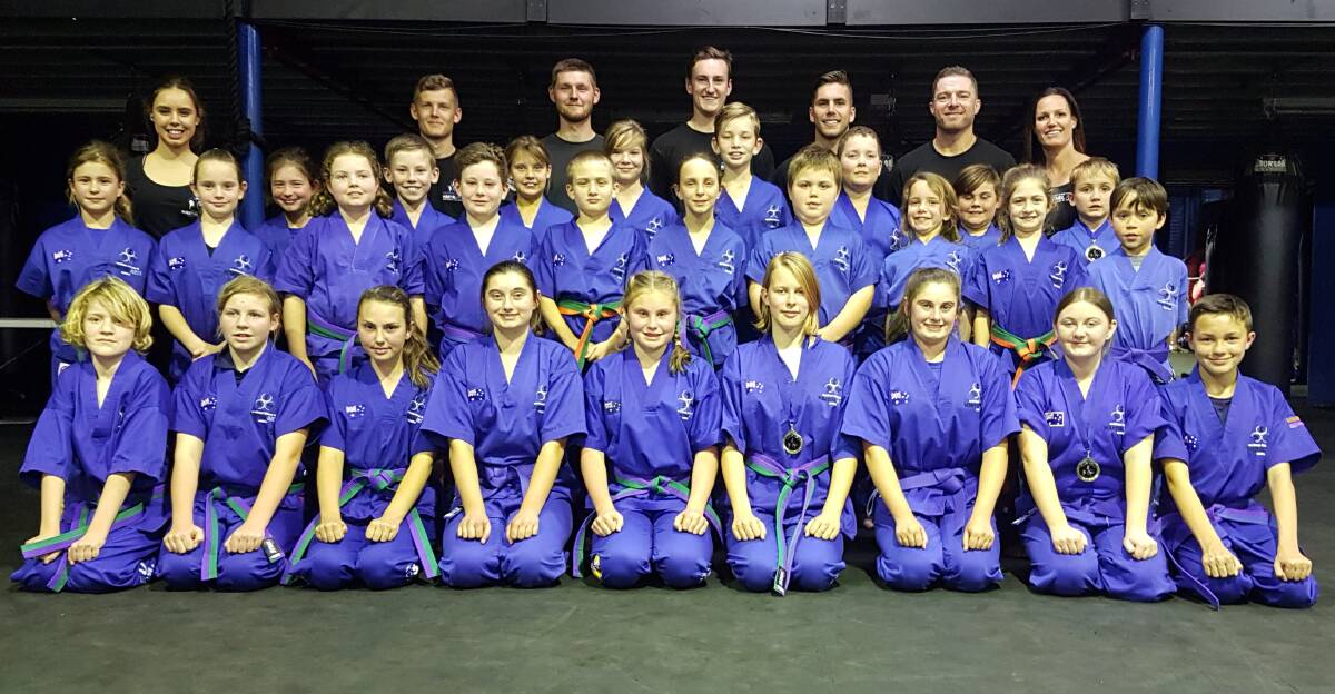 STARS OF THE FUTURE: Southern Fitness, Martial Arts and CrossFit Centre Bomaderry's junior kick defence - green and purple belts.