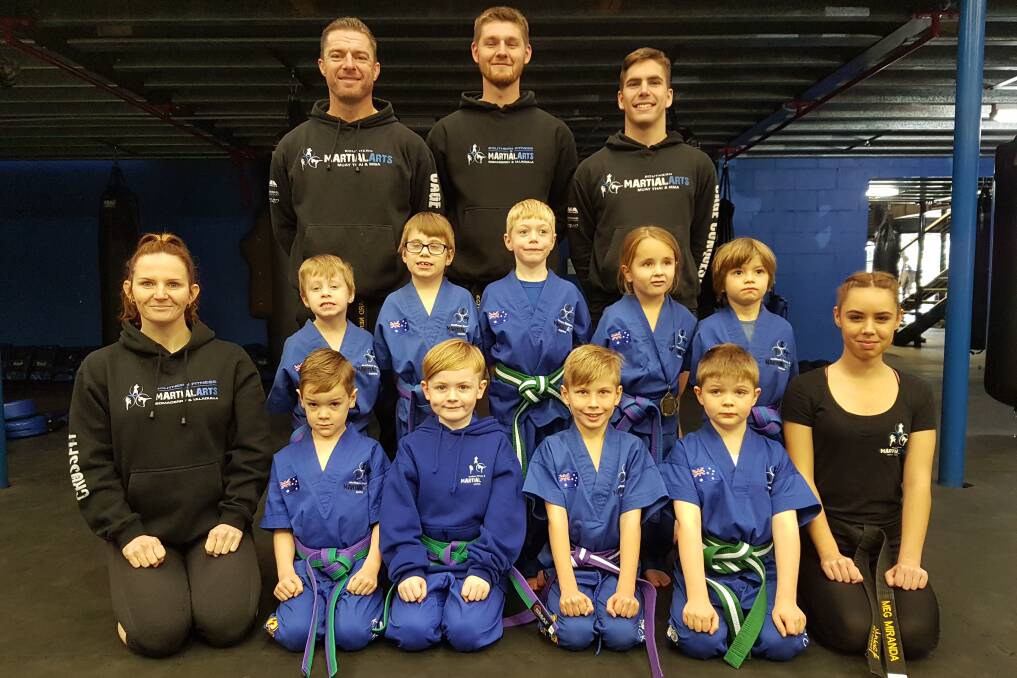 ALL SMILES: Southern Fitness and Martial Arts Centre Bomaderry's ninja intermediate, with their instructors, after their term two gradings.