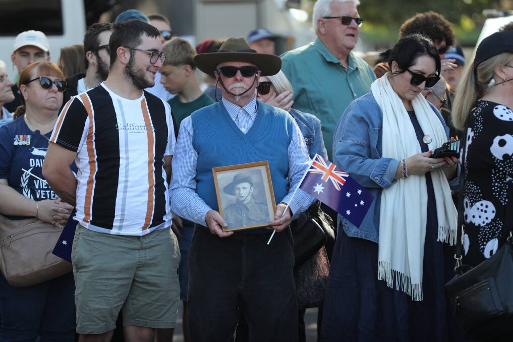 Stephen Rixon, with a photo of his father Jack, at the 2024 Wollongong Anzac Day march. Picture by Robert Peet