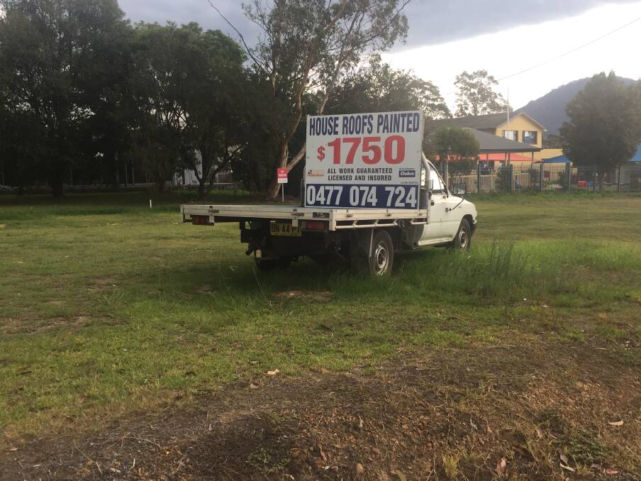 Signs like these, in Bomaderry, will be illegal by the end of February, and it will be council's job to enforce the law. Picture: Rebecca Fist