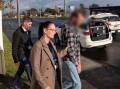Detectives lead Regan Pidding from a Warilla home following his arrest. Picture supplied by NSW Police Force