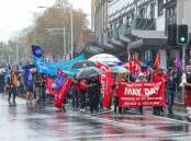 Workers march in the rain down Crown Street for the 2024 May Day March. Picture by Adam McLean