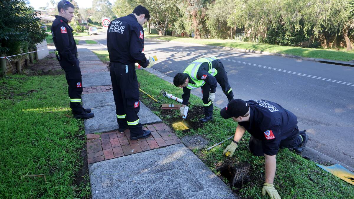 Firefighters Rhys Dawson, Josh Saacks, Josh Anderson and Matt Kelly uncovering a hydrant that had been buried under grass in Kiama. Picture by Sylvia Liber