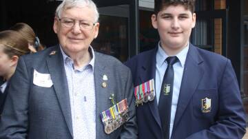 Colin Blundell was pictured with his grandson Nicholas Pavlis, who was wearing his great-grandfather's medals, following the service at St John The Evangelist Catholic High School. Picture by Glenn Ellard.